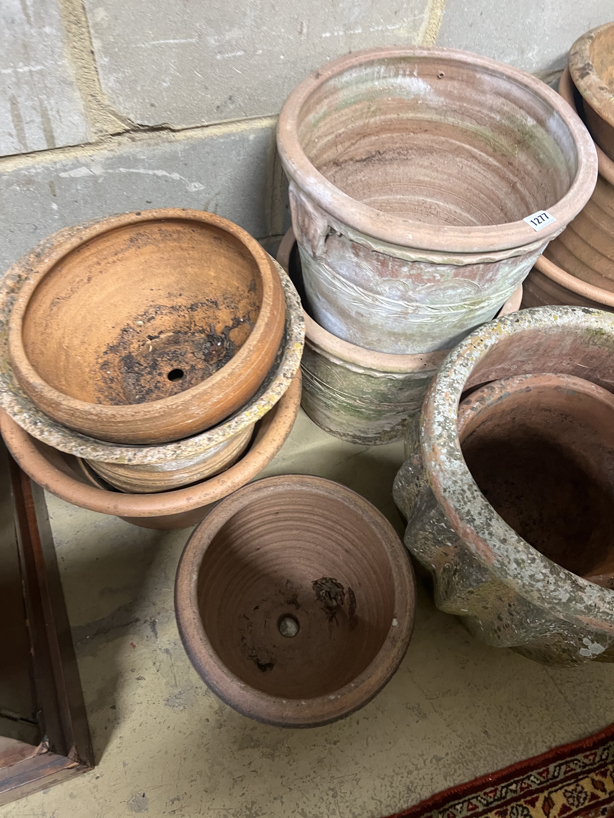 Fourteen assorted terracotta garden planters, largest diameter 42cm, height 40cm